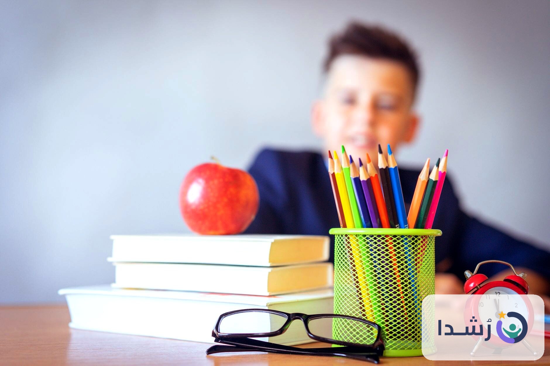 طفل يتعلم مع أدوات مدرسية مثل الكتب والأقلام