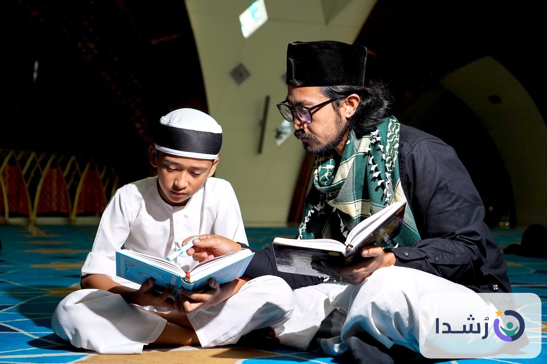 طفل يتعلم القراءة مع معلمه في مسجد